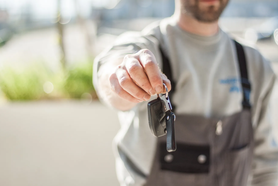 man offering car keys